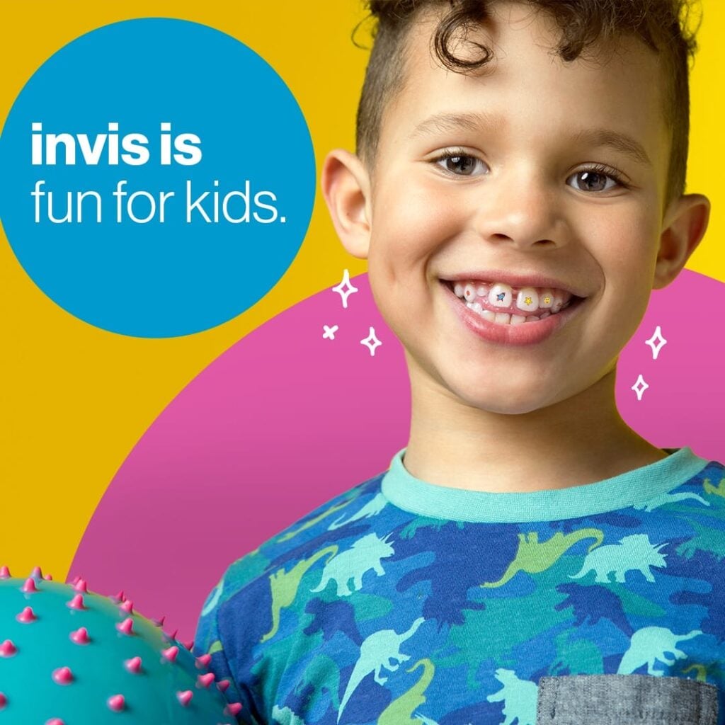 Smiling child with curly hair wearing a blue dinosaur shirt holds a spiky blue ball; text reads “invis is fun for kids” on a colorful background.