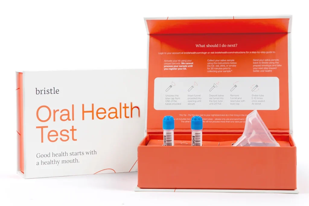An oral health test kit by Bristle, showing the box, two sample tubes, a funnel, and instructions for use inside the packaging—designed to help detect signs of gum disease and oral inflammation.