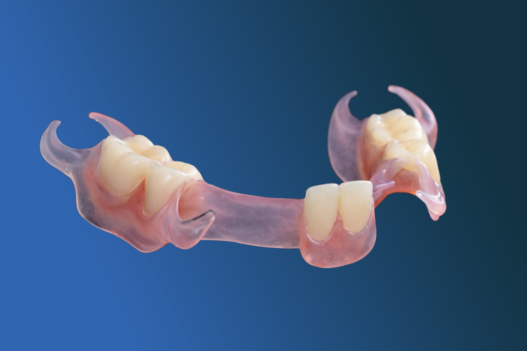 A partial dental denture with pink acrylic base and artificial teeth, representing restorative dentistry treatments, is shown against a blue gradient background.